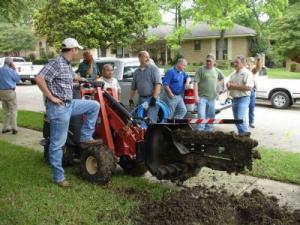 irrigation contractors in Sunrise florida installing a new system with a trencher